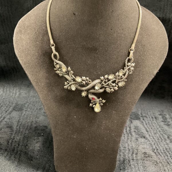 Vintage serpent entwined in vines pendant necklace with clear stones and red eye