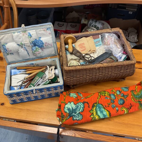 Floral vintage sewing box with sewing supplies inside.