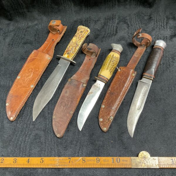Vintage sheath knives lot with leather sheaths, antique collectible blades.