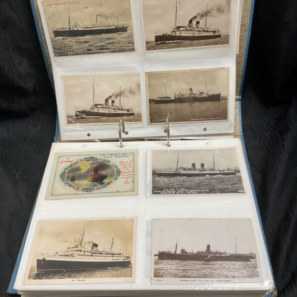 Open postcard album showing vintage steamer postcards including Isle of Jersey and St Helier