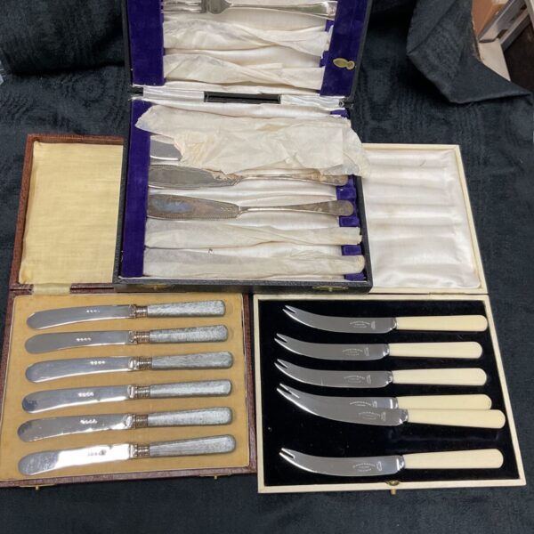 Vintage silver plate knife sets in original boxes.