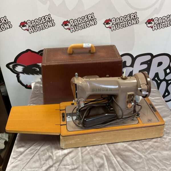 Vintage Singer 185K electric sewing machine with wooden base and brown carrying case
