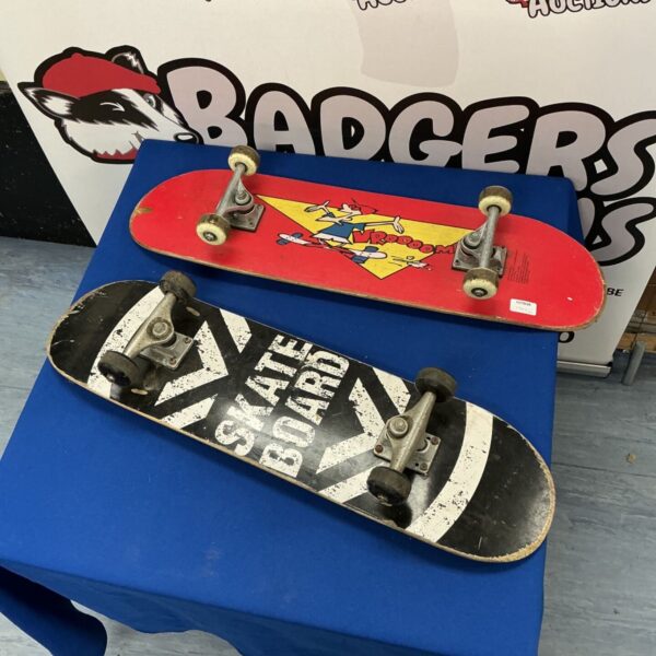 Red vintage skateboard with "Freedom" graphic and trucks.