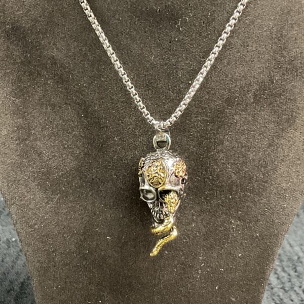 Vintage skull and snake pendant on a 24 inch silver-tone necklace