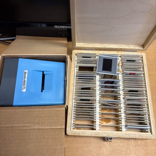 Vintage slide viewer with slides inside a wooden case.
