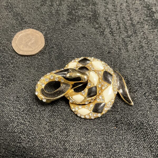 Vintage coiled snake brooch with black, cream and white enamel.