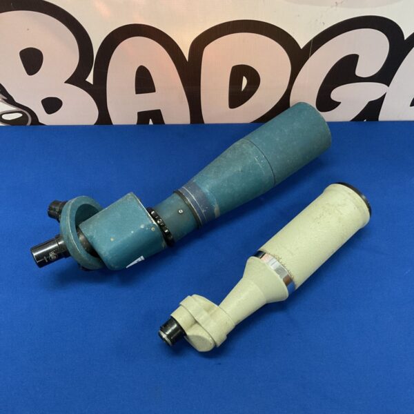 Vintage green and brass spotting scope with rotating eyepiece.