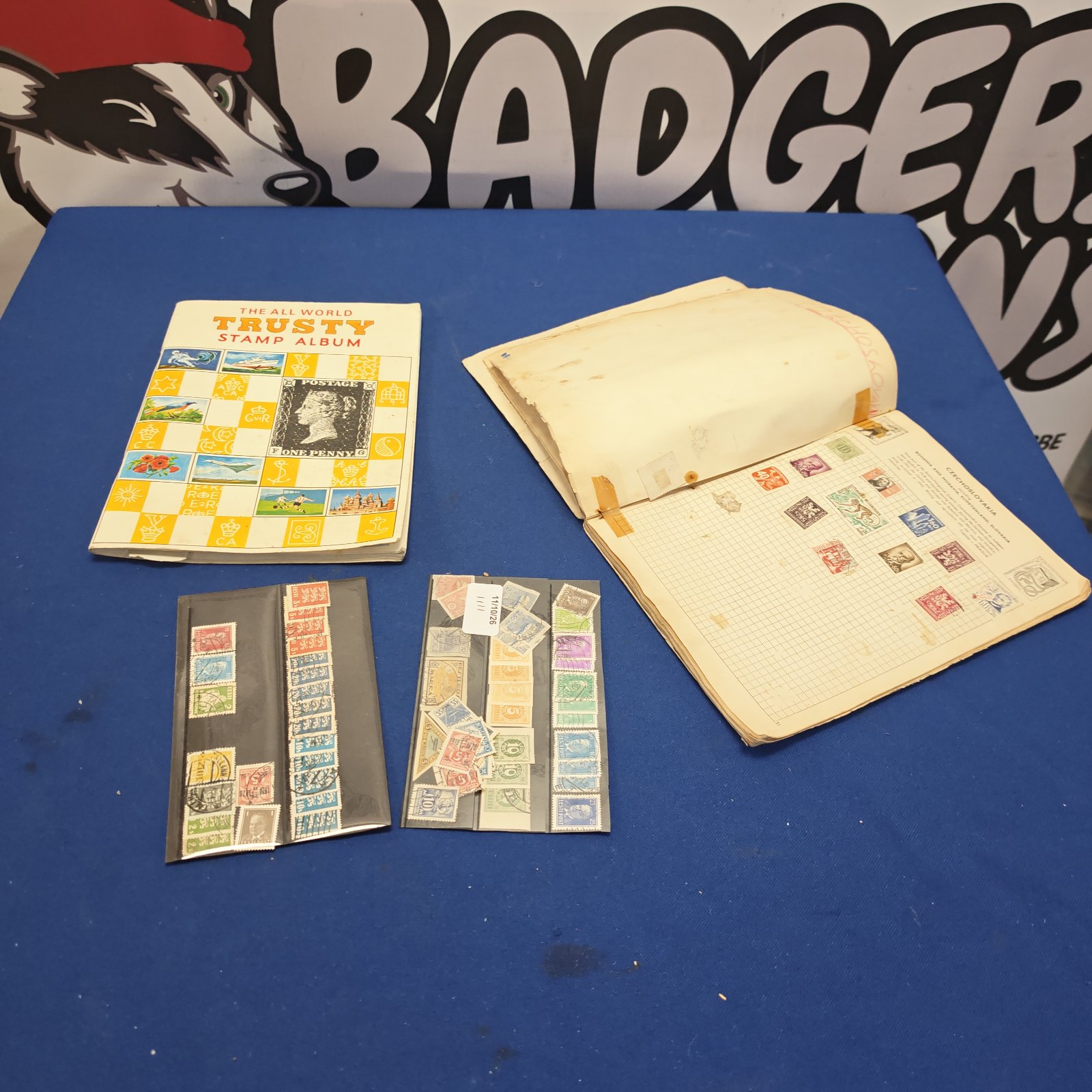 Vintage stamp albums and wallets filled with collectible stamps.