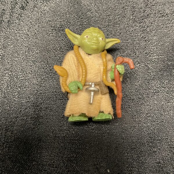 Vintage Star Wars Yoda figure with robe and walking stick.