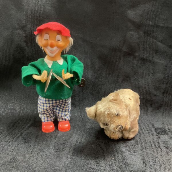 Vintage Steiff polar bear beside a vintage clockwork clown with cymbals