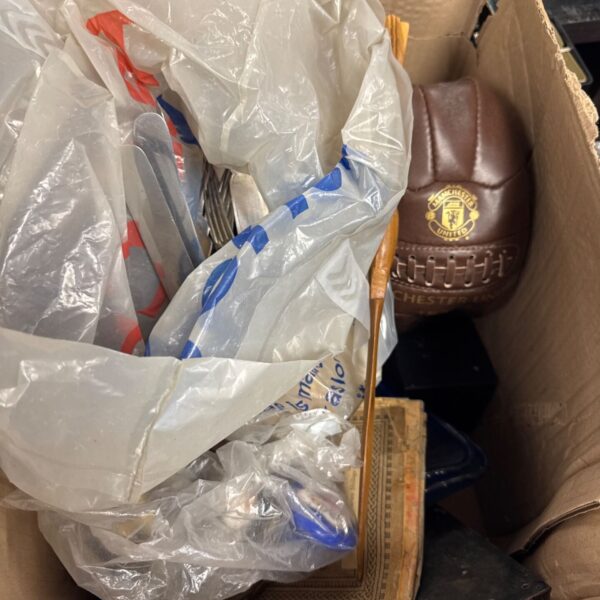 Cardboard box of mixed items including vintage style Manchester United football and packaged pieces