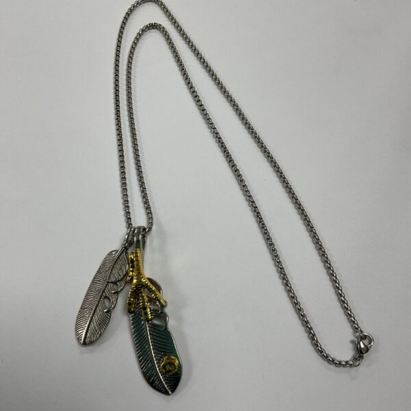 Vintage silver and gold tone talisman necklace with feather pendants and eagle claw