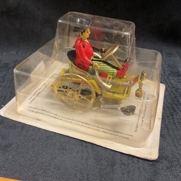Vintage tinplate clockwork car, a collectible toy in good condition.