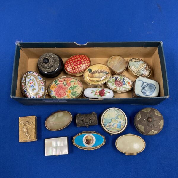 Collection of vintage trinket pots and boxes with cherub matchbox case on blue background