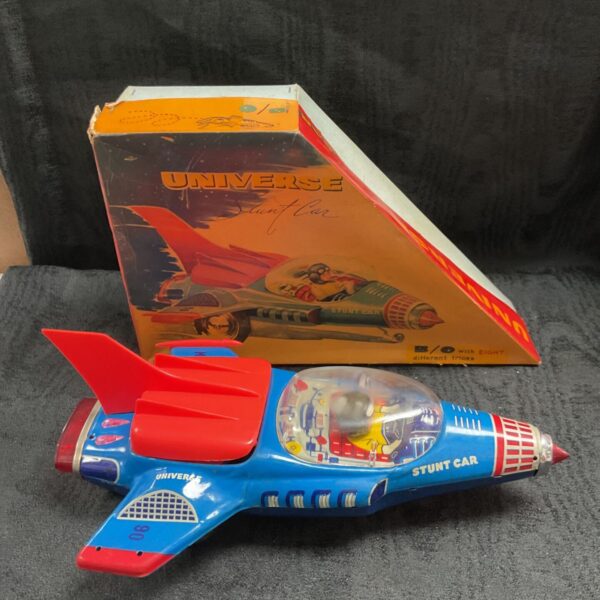 Vintage Universe tin plate Stunt Car beside its original box