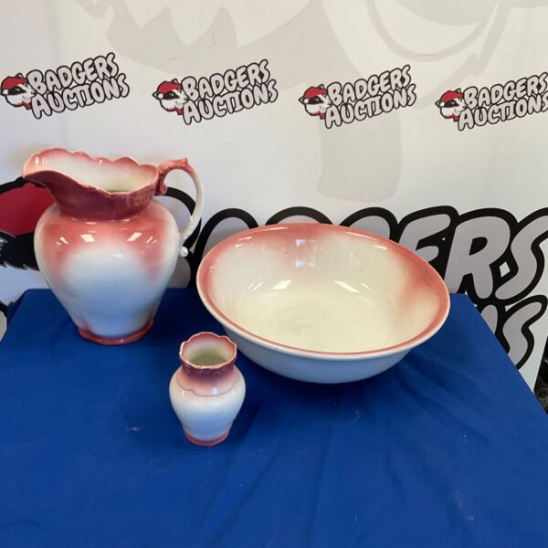 Vintage porcelain wash bowl and jug set with pink floral details.