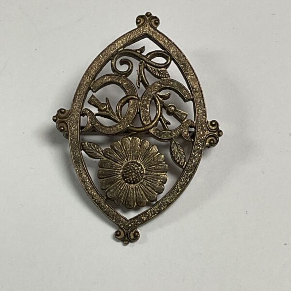 Vintage whitemetal openwork brooch with flower and C C scrollwork design