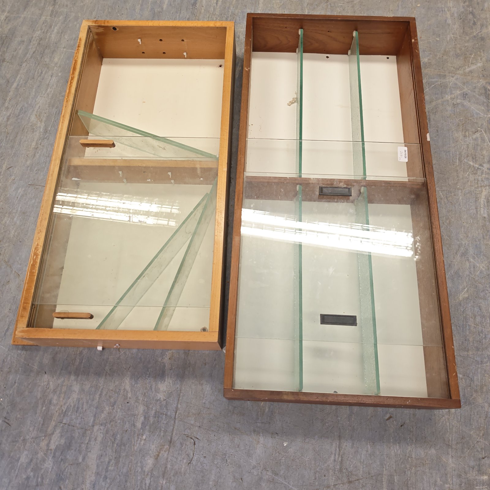 Vintage wooden display cabinets with glass doors and shelves.