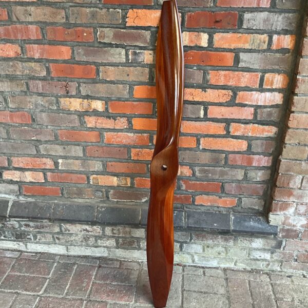 Vintage wooden airplane propeller for display or aviation decor.