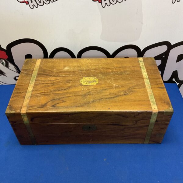 Vintage wooden writing slope with brass bindings and corner mounts, closed