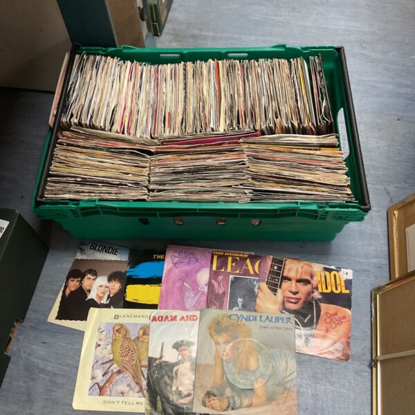 Large collection of vintage vinyl records in a plastic crate.