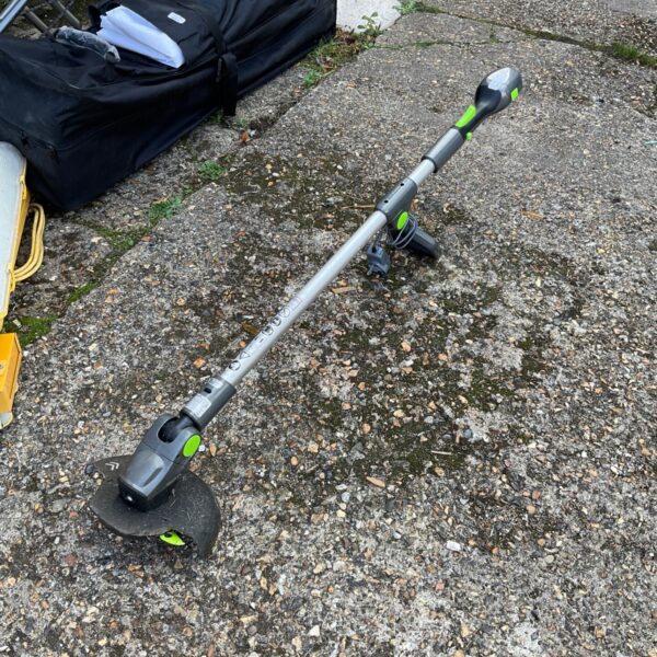 Vtech garden strimmer with charger, used condition, outdoor tool.