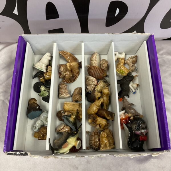 Collection of Wade Whimsies animal ornaments arranged in a divided box