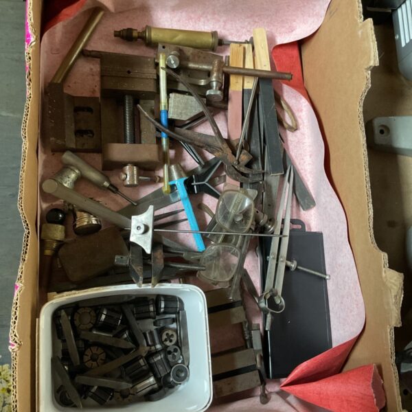 Tray of watchmaker's tools with collets, files, calipers and small lathe attachments