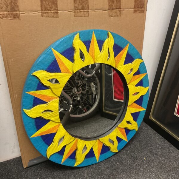 Vintage 1980s Wendy Earley sunburst mirror with blue and yellow design.