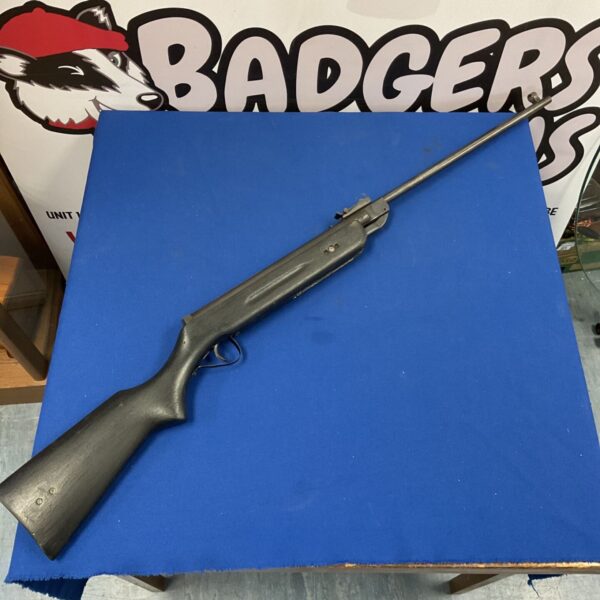 Westlake black air rifle with dark stock and long steel barrel on blue surface