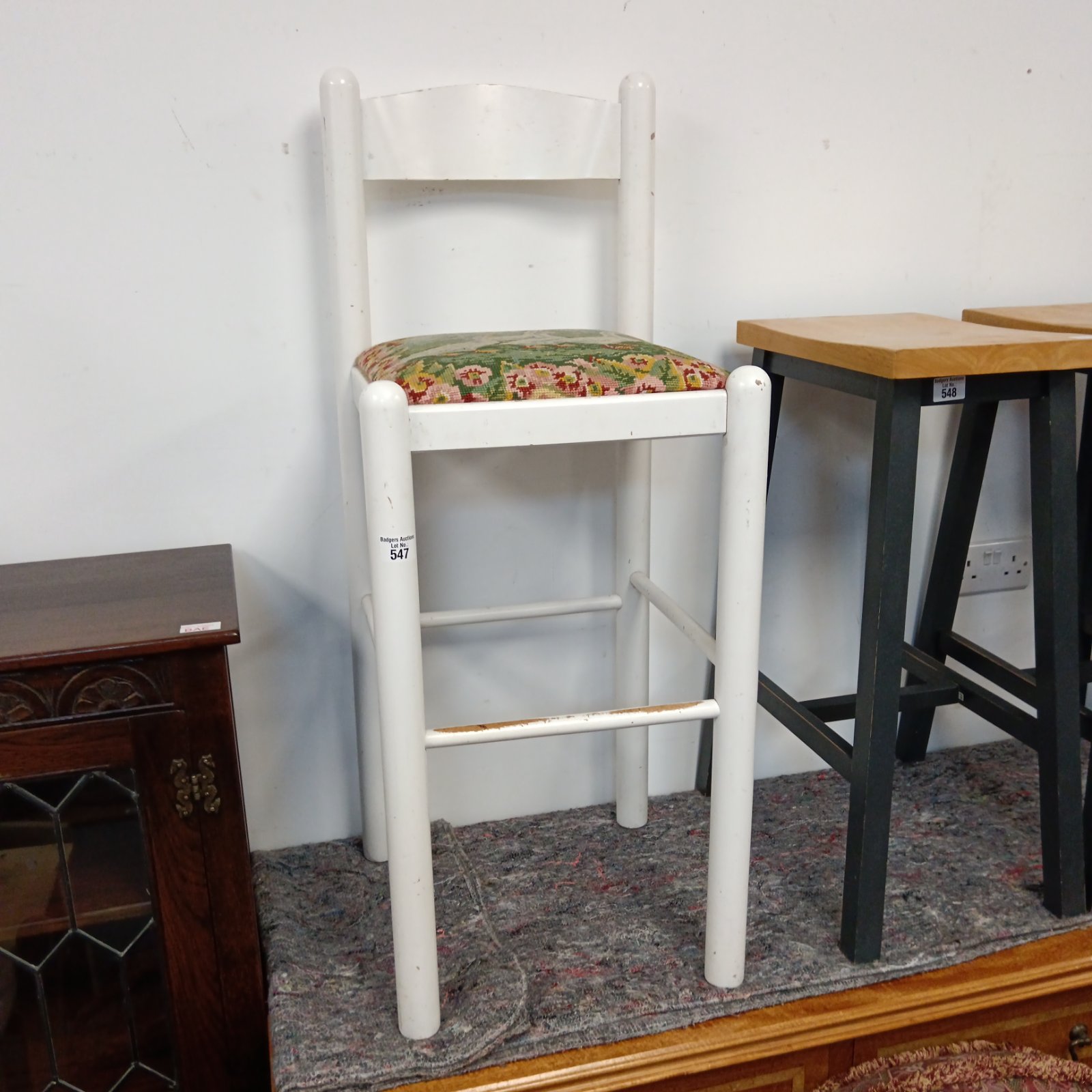 White bar stools with floral tapestry seats, vintage kitchen furniture.