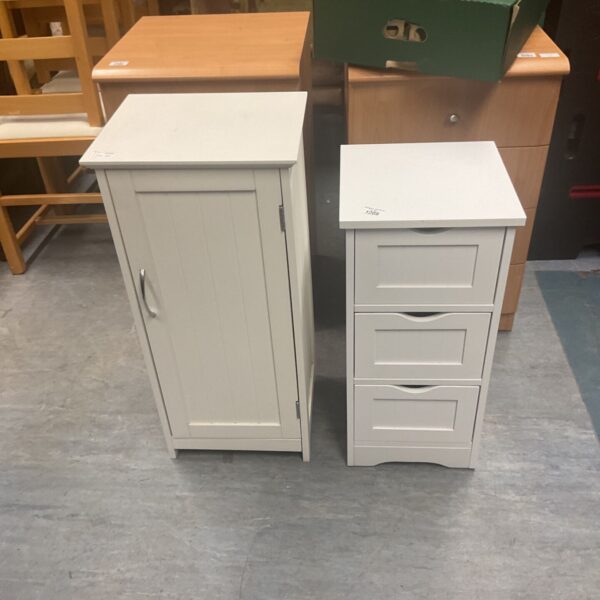 White painted bathroom cabinet with a single door and shelf.