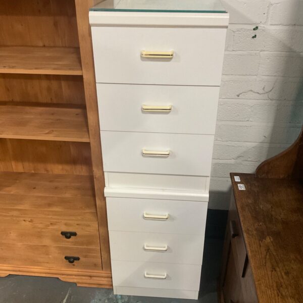 White three drawer chest with glass top and cream and gold handles