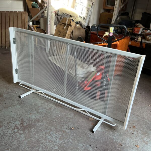 White metal folding guest bed with expanded mesh panel and hinged frame