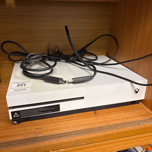 White Microsoft Xbox One S gaming console with controller and cables.