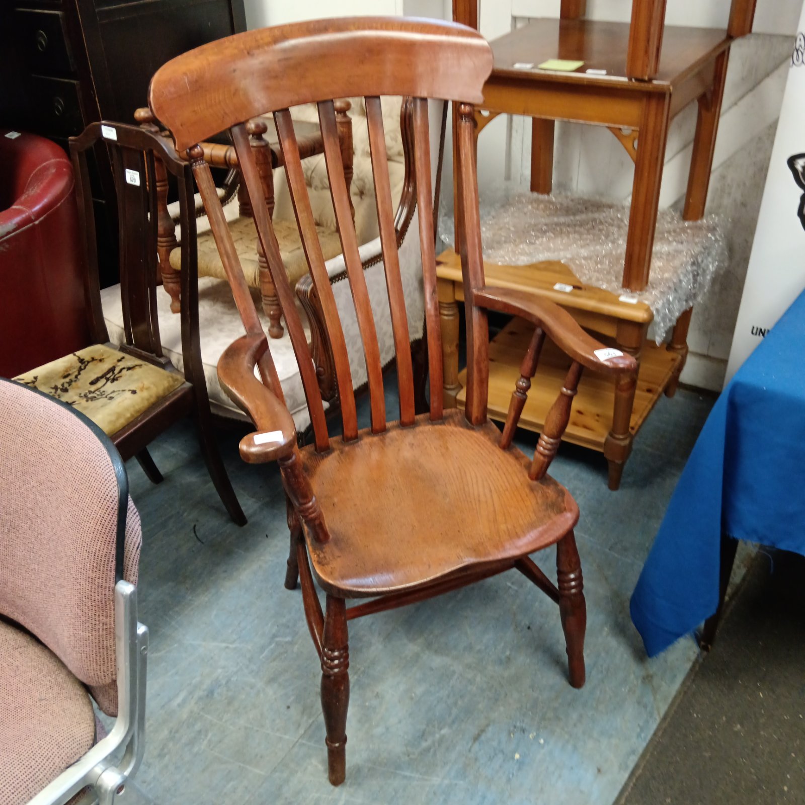 Traditional Windsor armchair with slat-back, side view.
