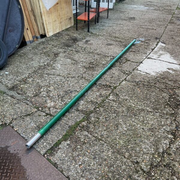 Green tubular windsurf sail pole with silver metal end section