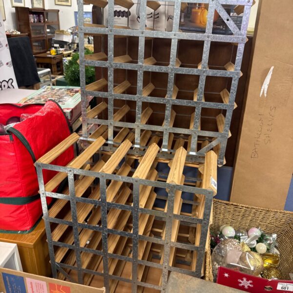 Lot of three wooden and metal wine bottle racks for wine storage.
