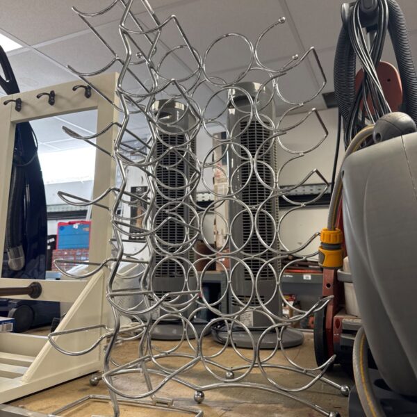 Two metal wire frame bottle racks for wine display.