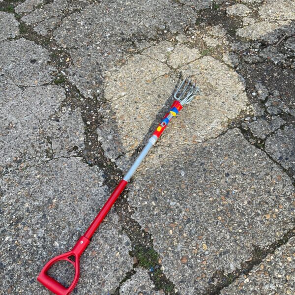 Red handled Wolf garden hand fork and hoe set for gardening.