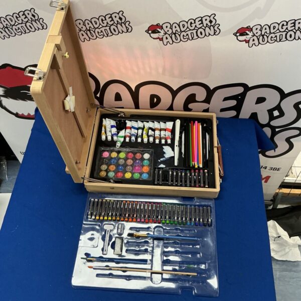 Wooden art supplies box filled with paints and pencils.