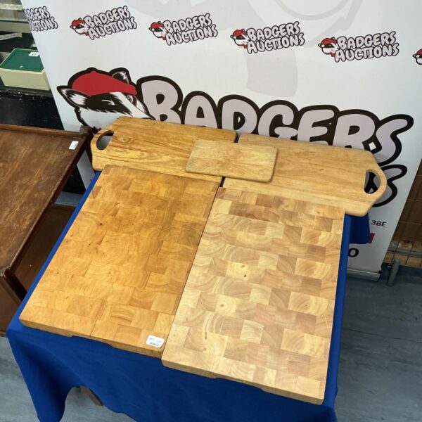 Bundle of five wooden chopping boards for kitchen use.