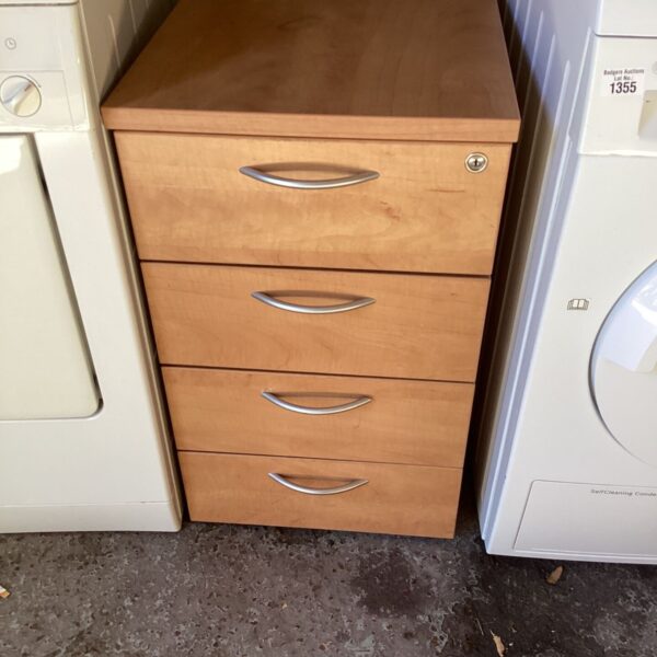 Wooden four-drawer office unit for storing files and office supplies.