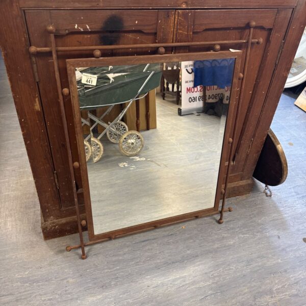Antique wrought iron mirror with bevel glass, vintage home decor.