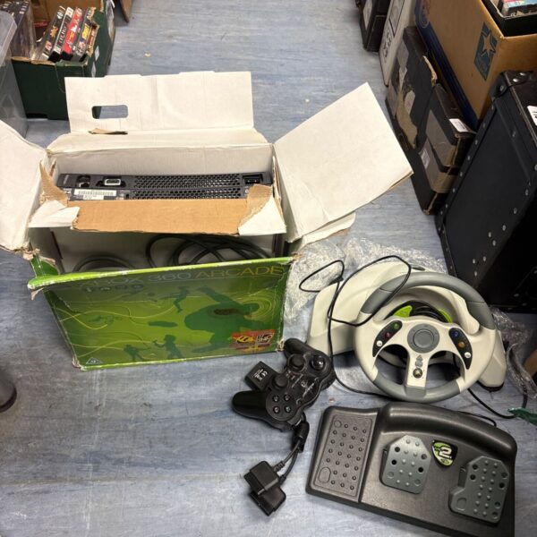 Xbox 360 console with racing wheel and pedal set in a lot.