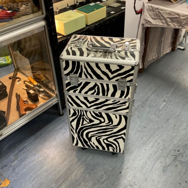 Closed zebra print rolling aluminium makeup case with chrome handle and wheels
