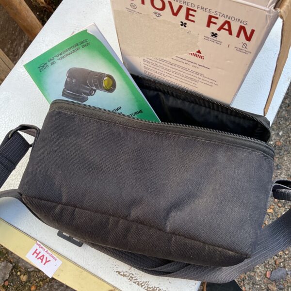 Zenit night vision scope beside black carry pouch and Russian-language leaflet
